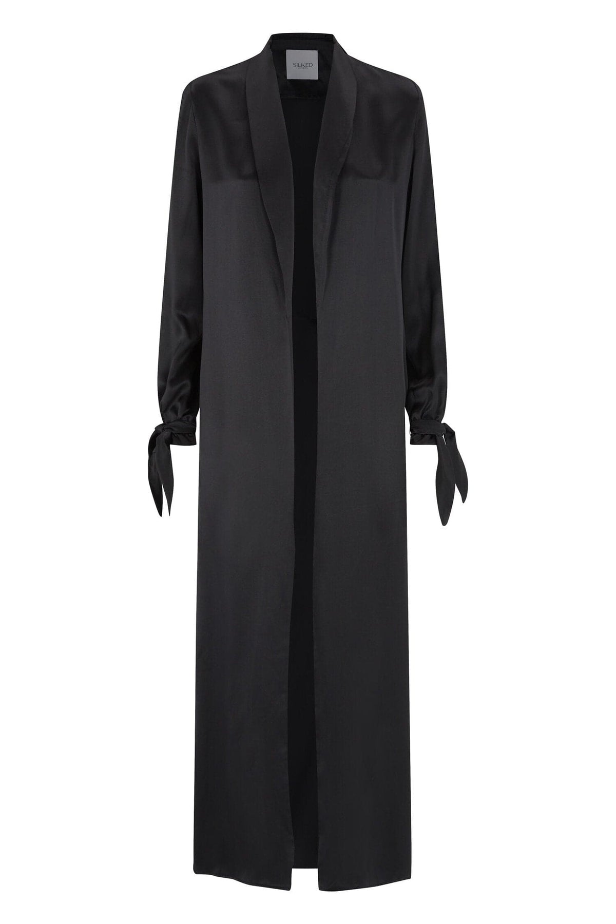 Black Silked silk duster coat hanging on a wooden hanger, showcasing its lightweight, flowing silk fabric and elegant design.