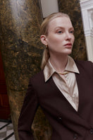 Oyster Silked mini shirt dress with long sleeves, collared neckline, and button front, styled for casual or formal occasions.