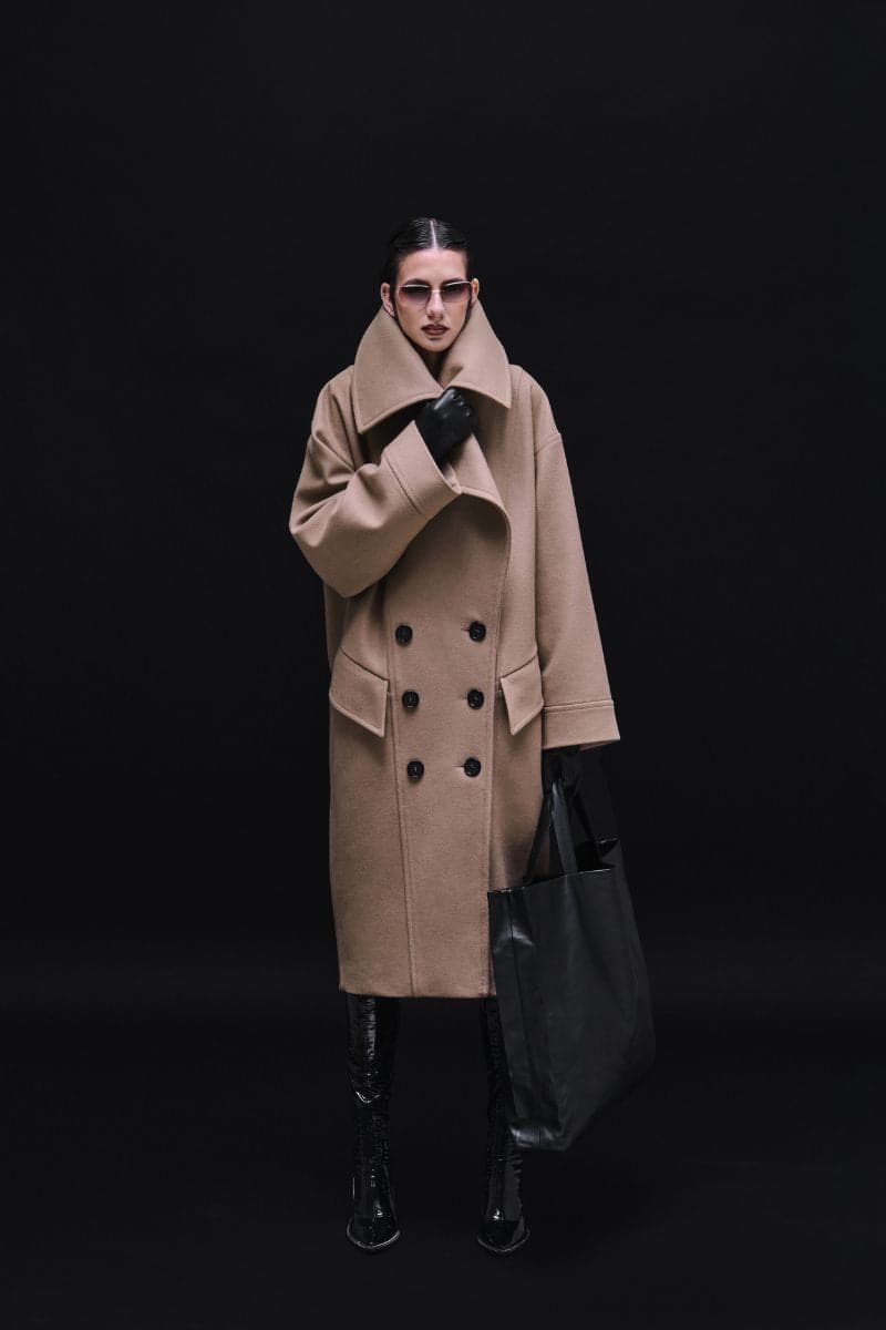 Vaska double-breasted relaxed coat in caramel color, showing front view with lapels and long sleeves, size XS.