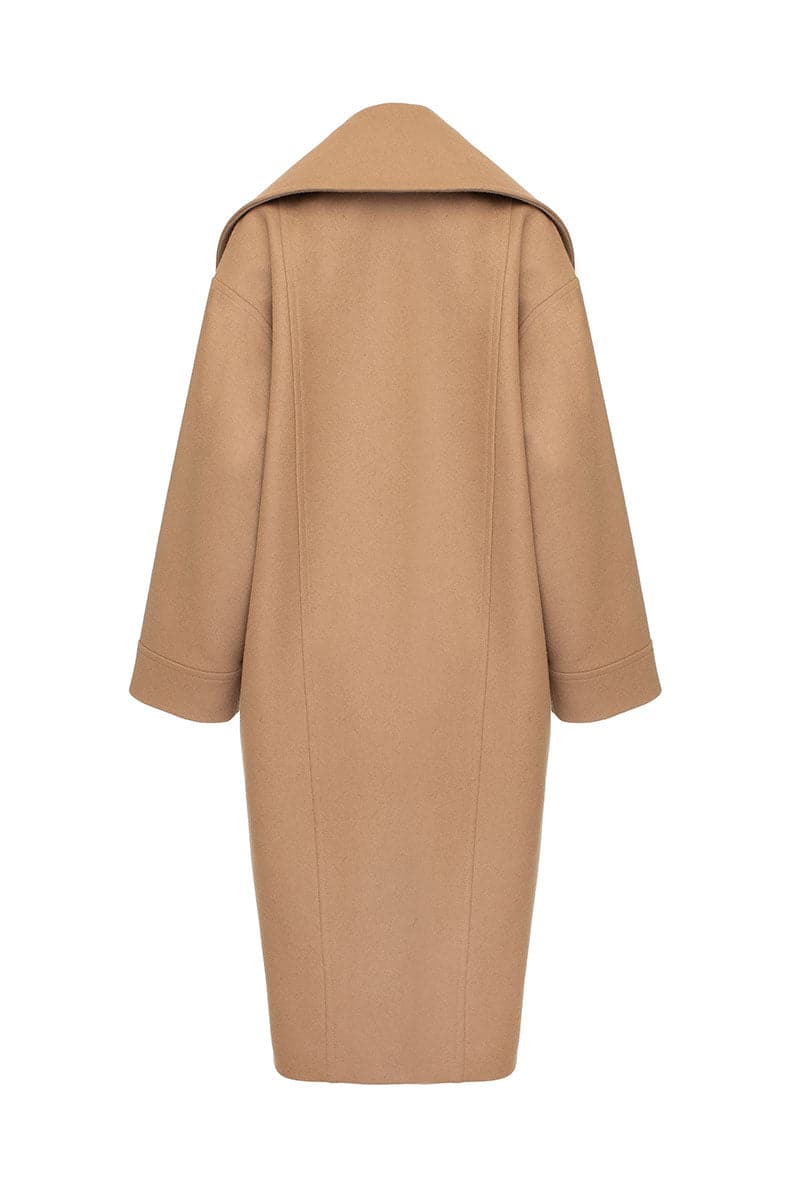 Vaska double-breasted relaxed coat in caramel color, shown on a model, with a tailored fit and classic lapel design.