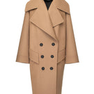 Vaska double-breasted relaxed coat in caramel color, shown on a model, featuring a classic collar and stylish tailoring.