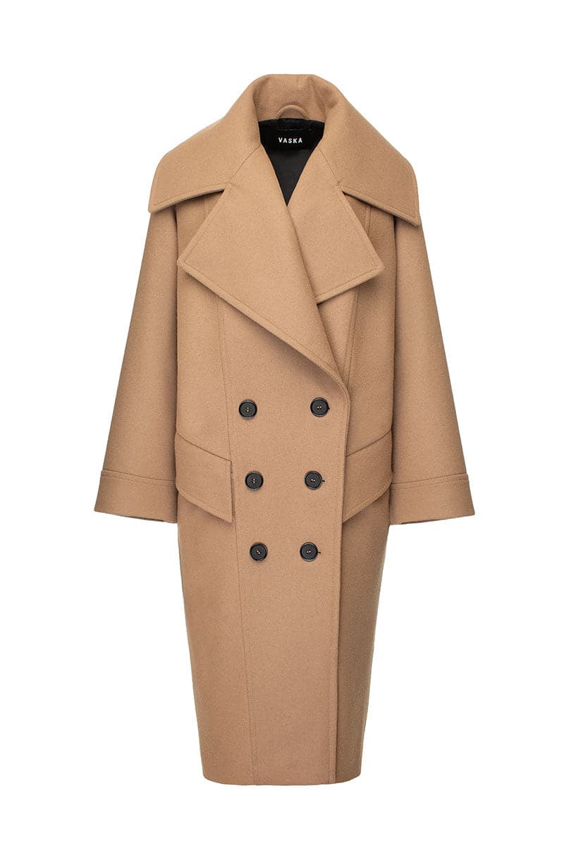 Vaska double-breasted relaxed coat in caramel color, shown on a model, featuring a classic collar and stylish tailoring.