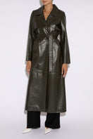 Dark khaki leather trench coat by Verheyen, featuring a tailored fit and classic design, shown on a model.