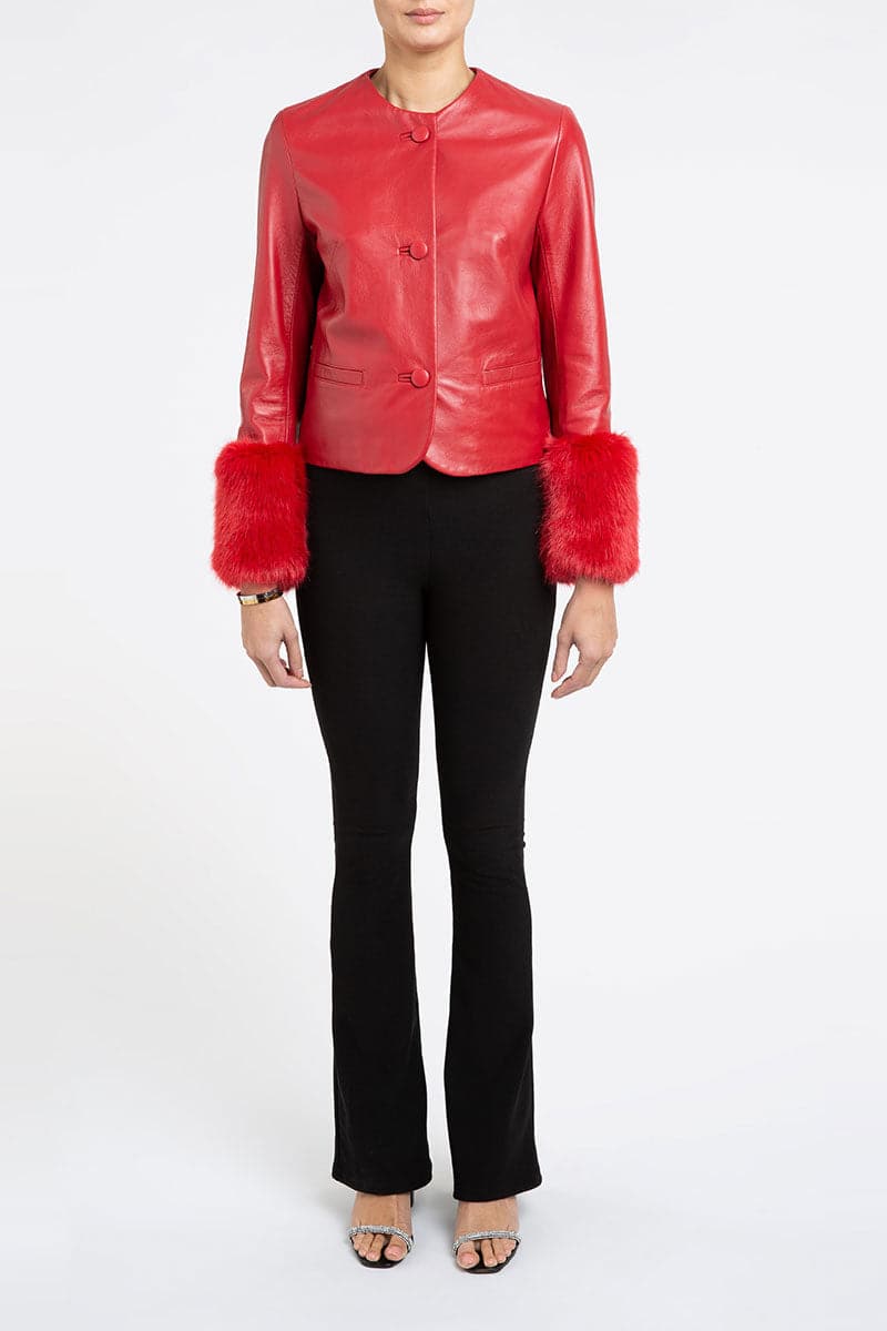 Red VITA cropped faux fur jacket by Verheyen, stylish and cozy, shown on a model with a close-up of the jacket's plush texture.
